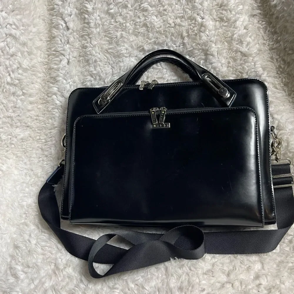 Abbi New York Laptop/Briefcase Carrier Black leather inside padded fabric.